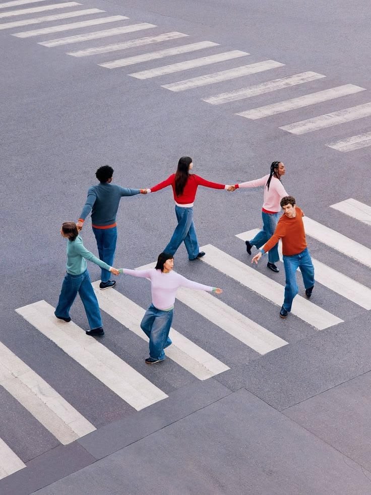 Commuters crossing a busy street